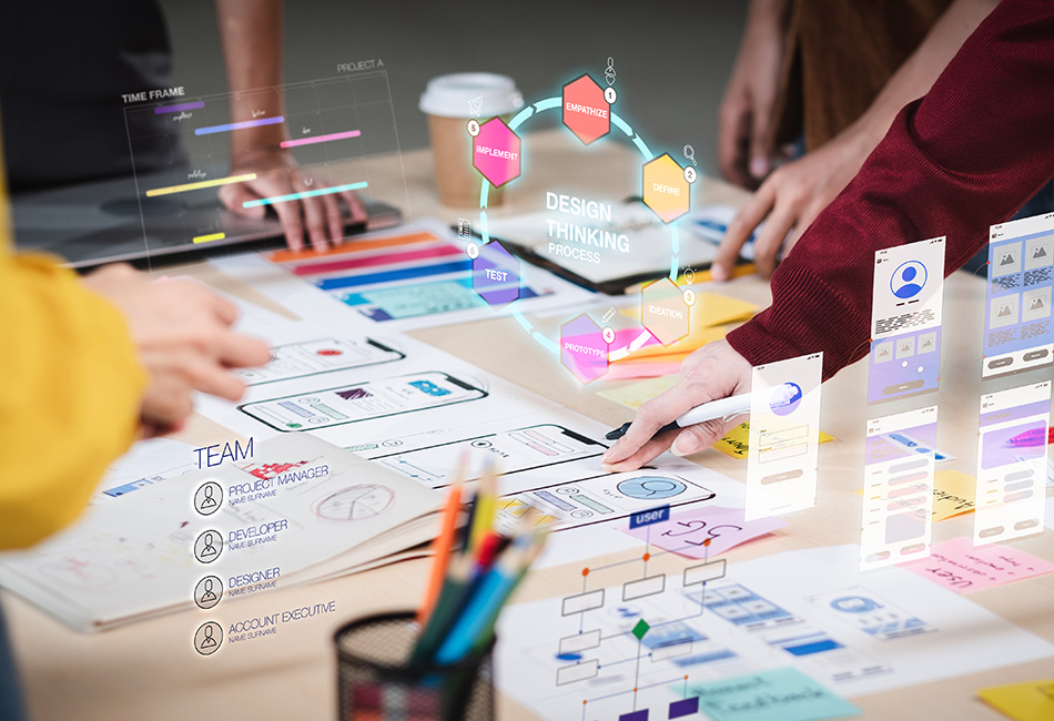 A close up of employees hands working on the design process using paper and hand drawn diagrams